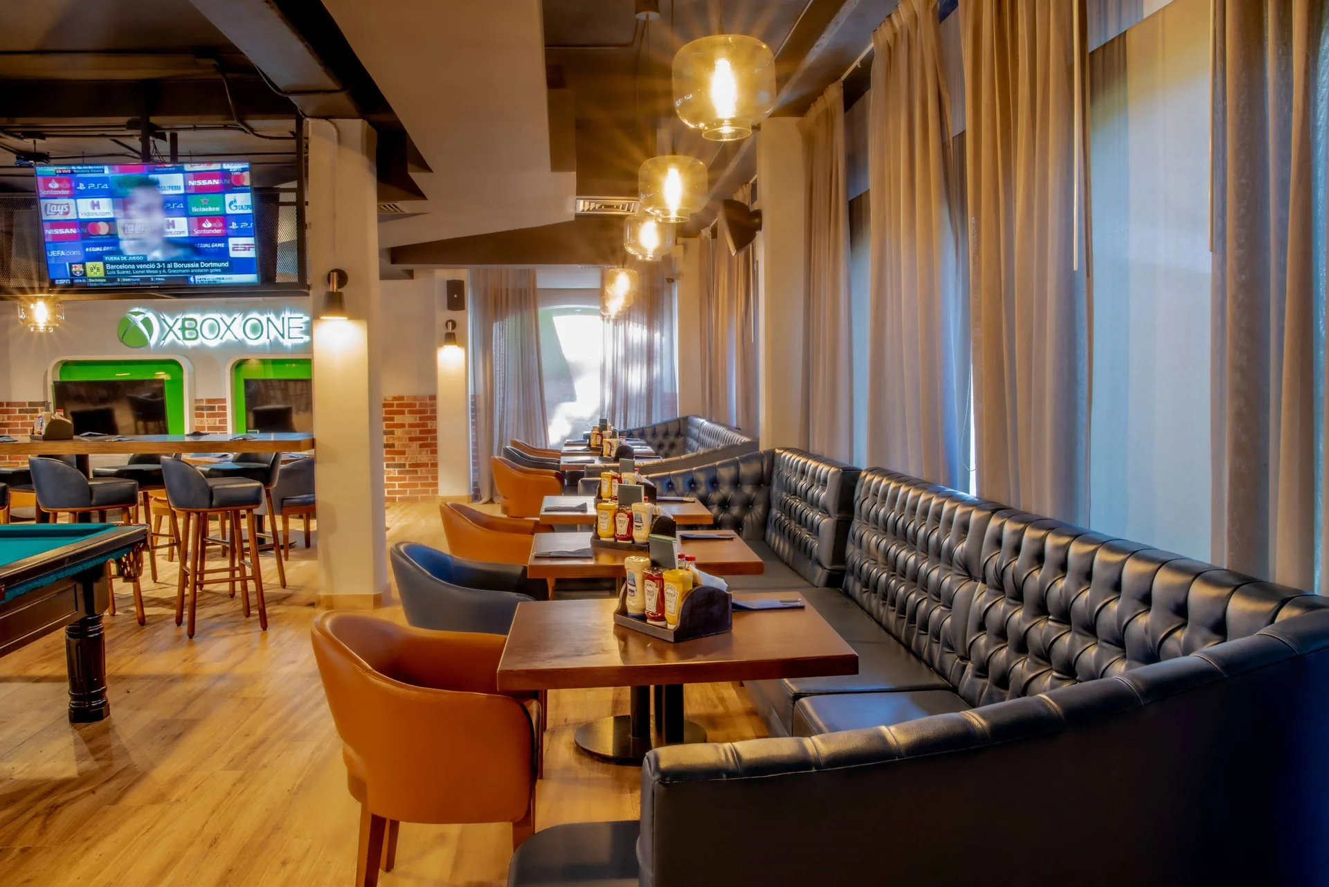 Sports bar seating and game screens at Grand Palladium Vallarta Resort & Spa.