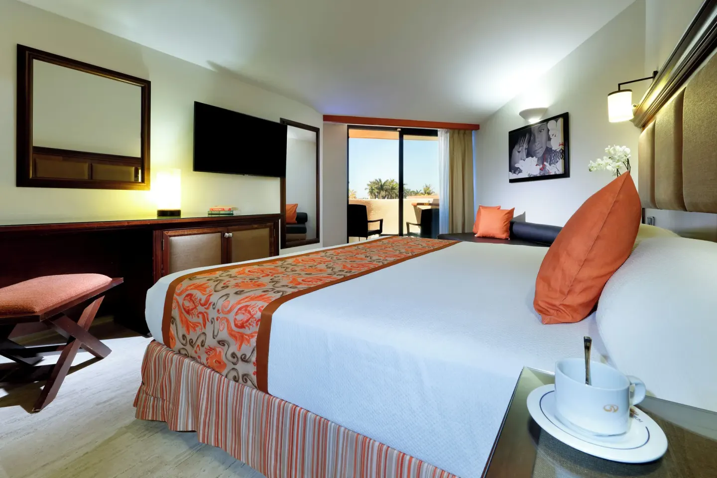 Deluxe Ocean View king bed and balcony doorway at Grand Palladium Vallarta Resort & Spa.