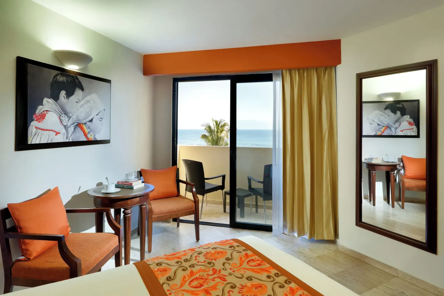 Deluxe Ocean View room seating area and balcony at Grand Palladium Vallarta Resort & Spa.