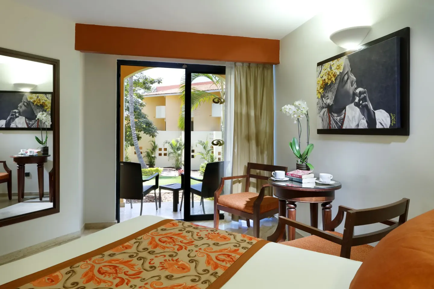Deluxe Room seating area and patio doors at Grand Palladium Vallarta Resort & Spa.