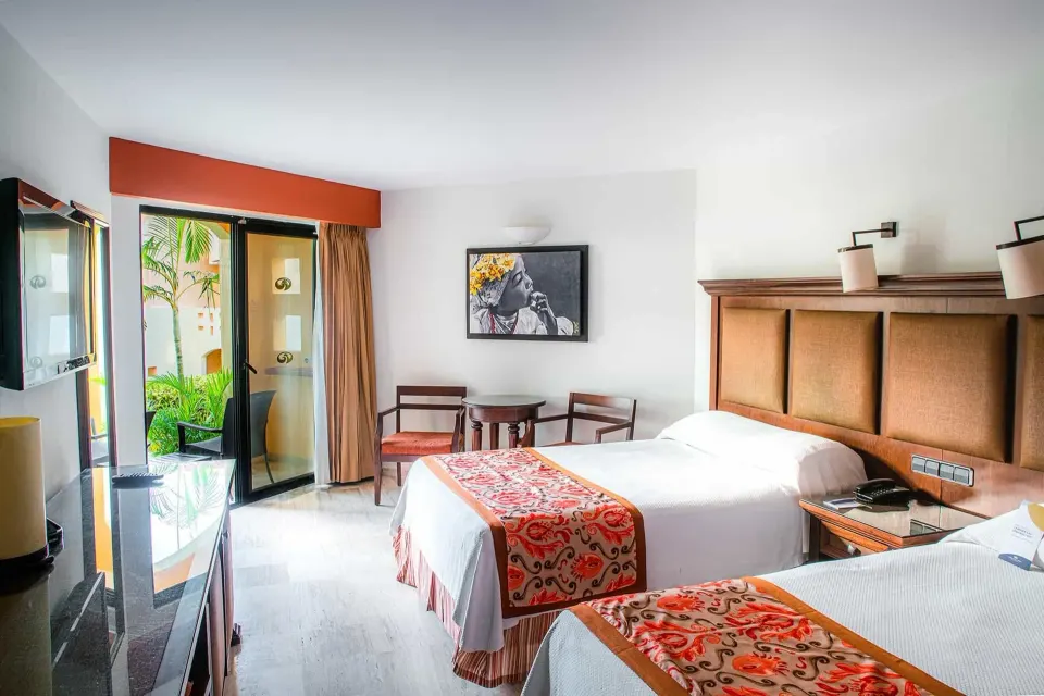 Deluxe Room with two beds and patio doors at Grand Palladium Vallarta Resort & Spa.