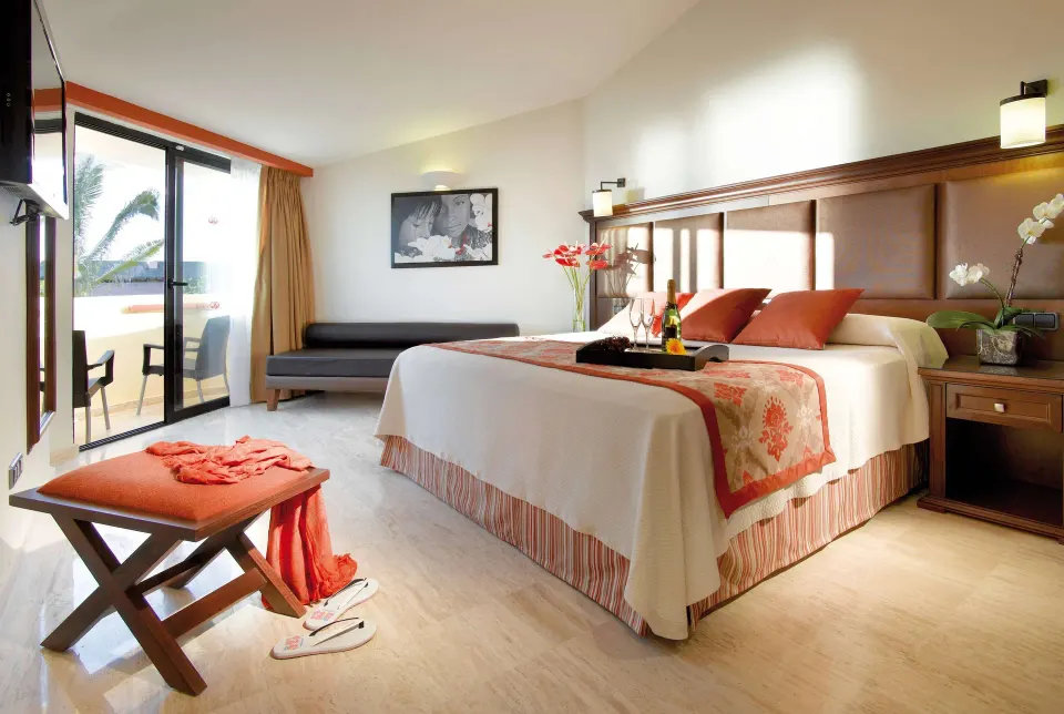 Deluxe Suite Ocean View king bedroom with balcony doors at Grand Palladium Vallarta Resort & Spa.