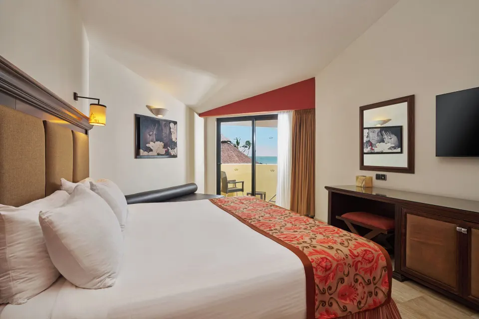 Deluxe Suite Ocean View bed and balcony at Grand Palladium Vallarta Resort & Spa.