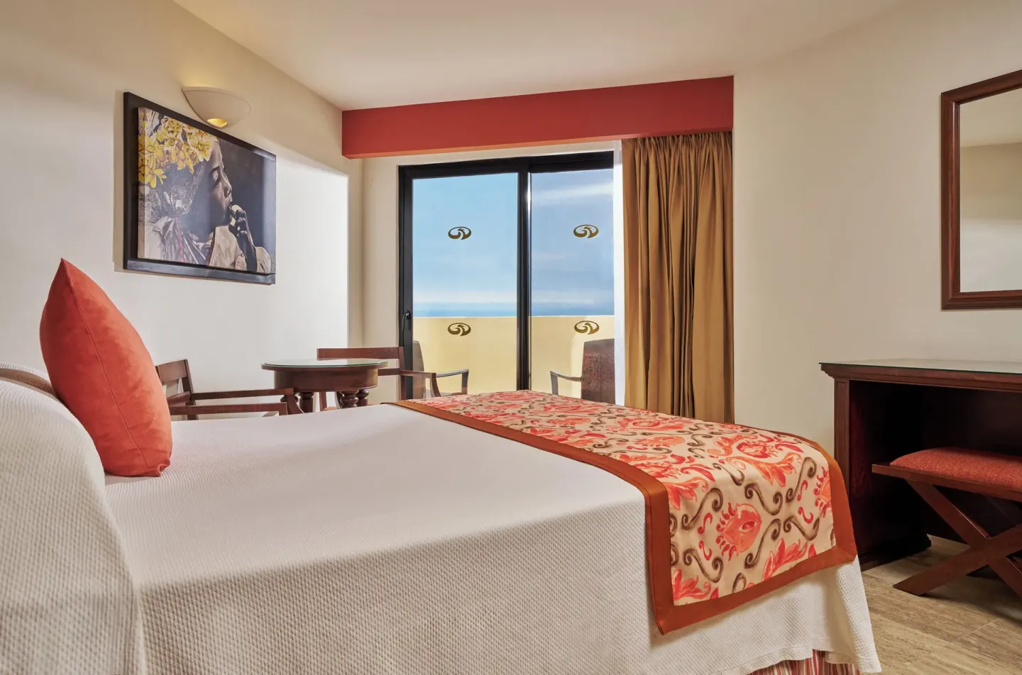 Deluxe Suite Ocean View bed and balcony at Grand Palladium Vallarta Resort & Spa.