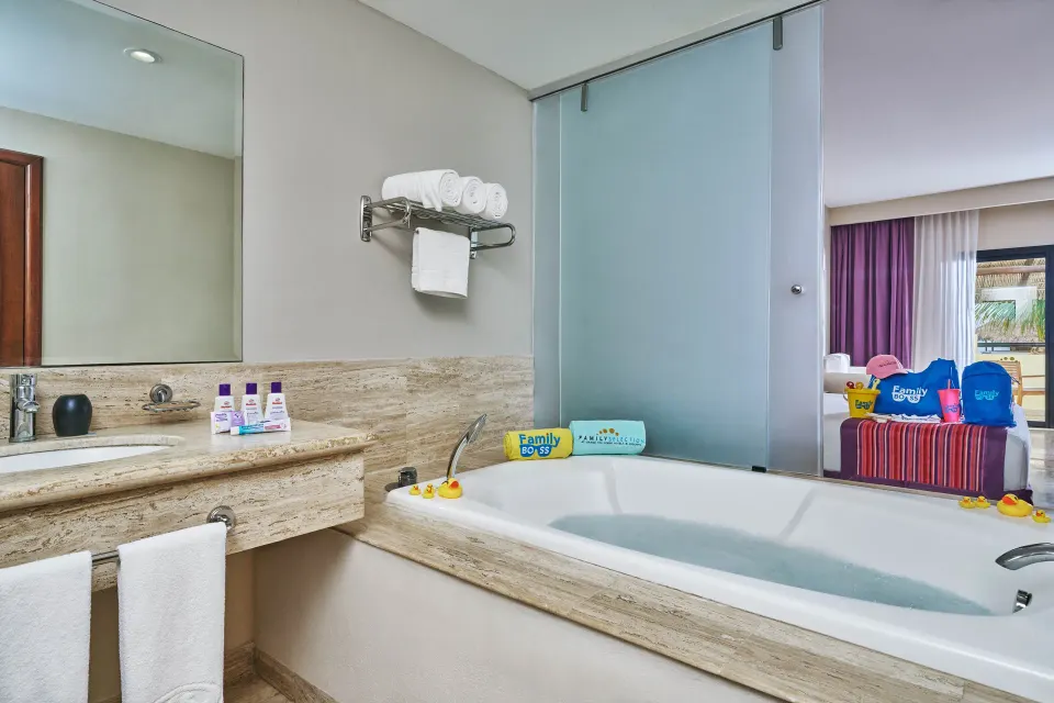 Family Selection Junior Suite bathroom with tub and vanity at Grand Palladium Vallarta Resort & Spa.