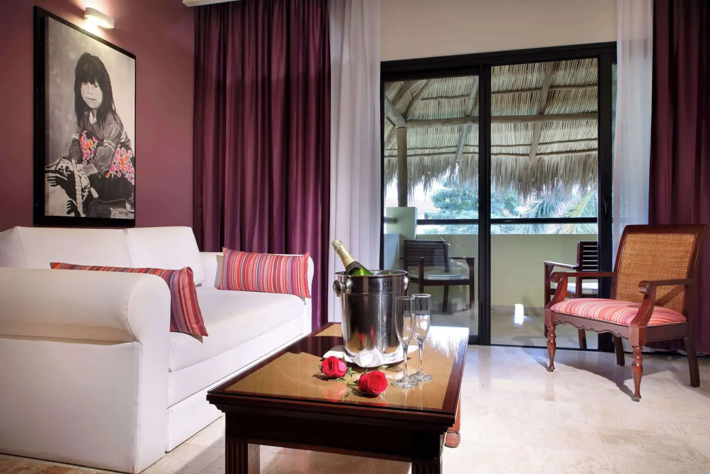 Family Selection Junior Suite sitting area with sofa and balcony at Grand Palladium Vallarta Resort & Spa.