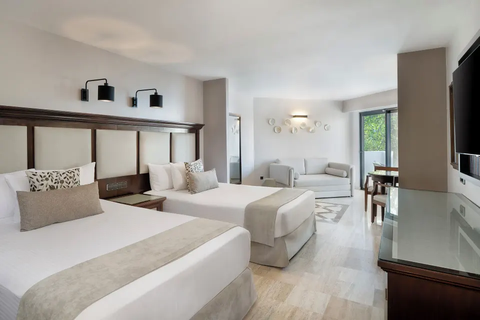 Junior Suite with two beds and sitting area at Grand Palladium Vallarta Resort & Spa.