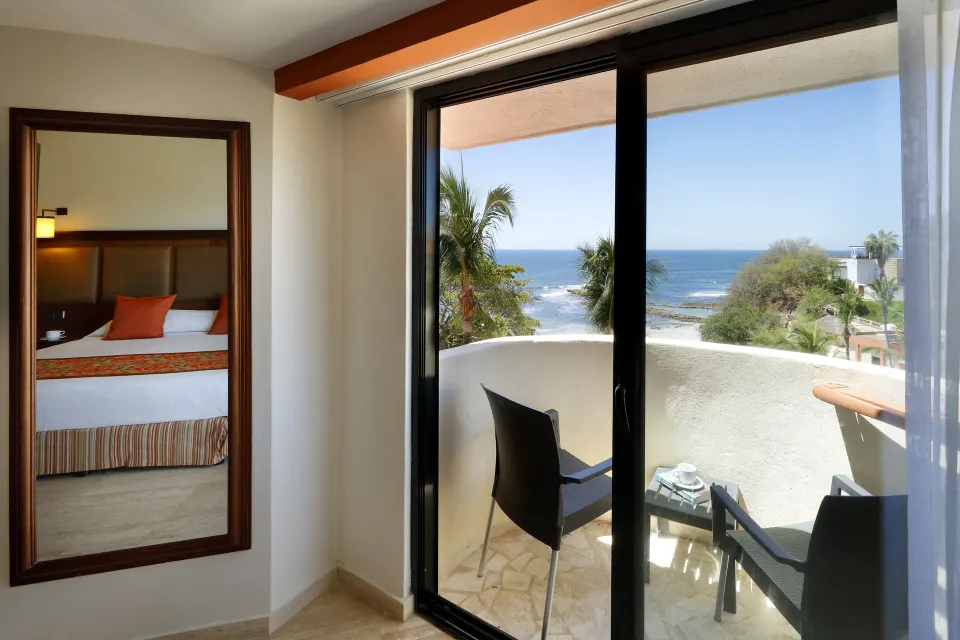 Suite Panoramic Ocean View balcony seating and ocean view at Grand Palladium Vallarta Resort & Spa.