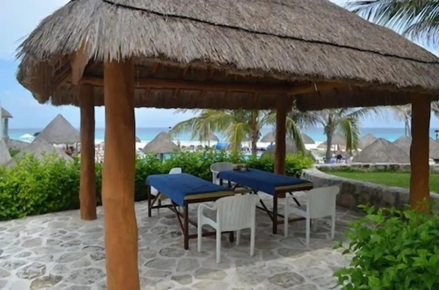 Thatched beach palapa with massage tables at Grand Park Royal Cancun.