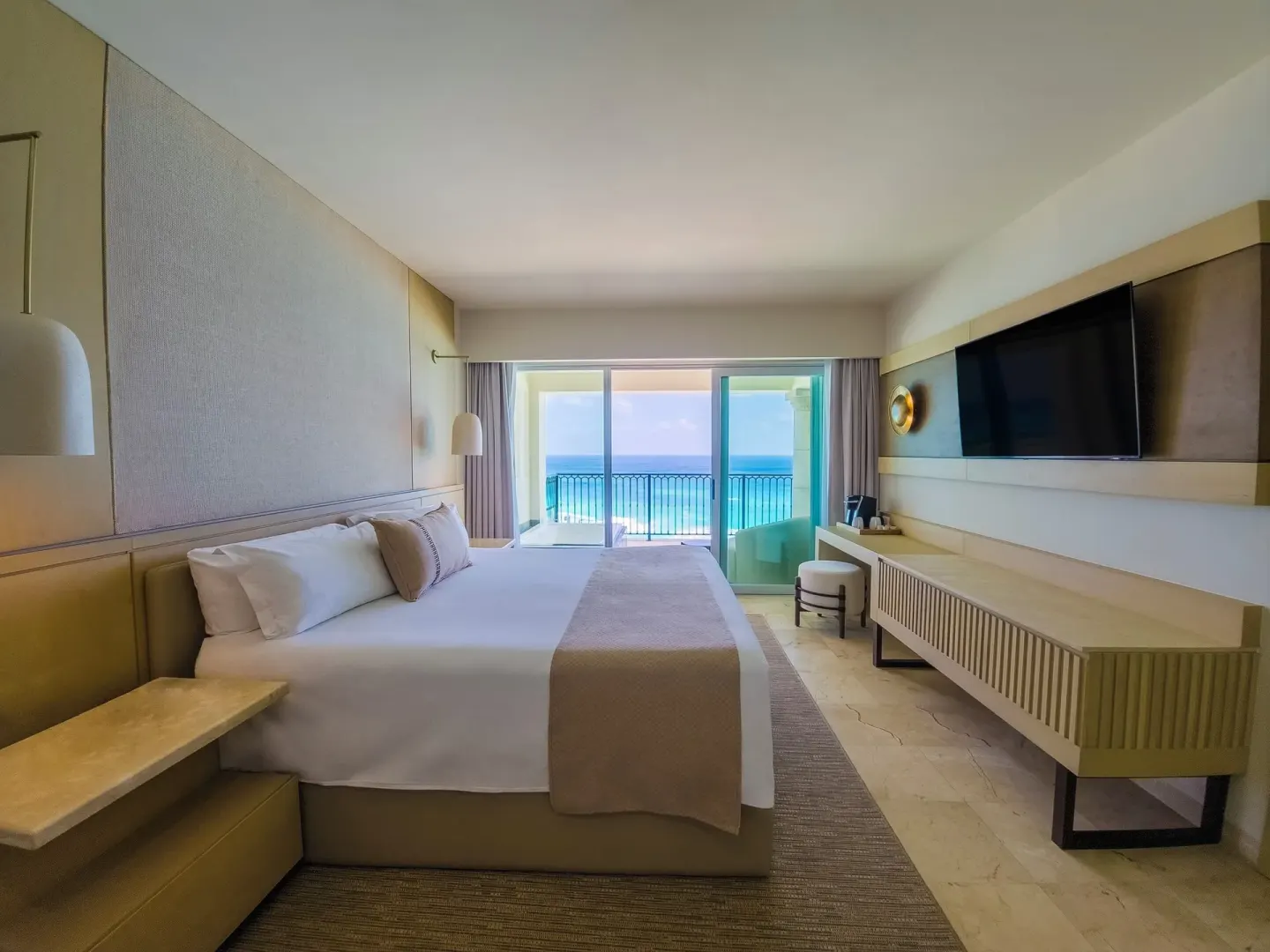 Ocean view guest room with king bed and balcony at Grand Park Royal Cancun.