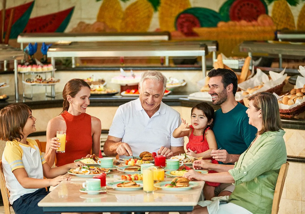 Family dining at a buffet restaurant at Grand Park Royal Cancun.