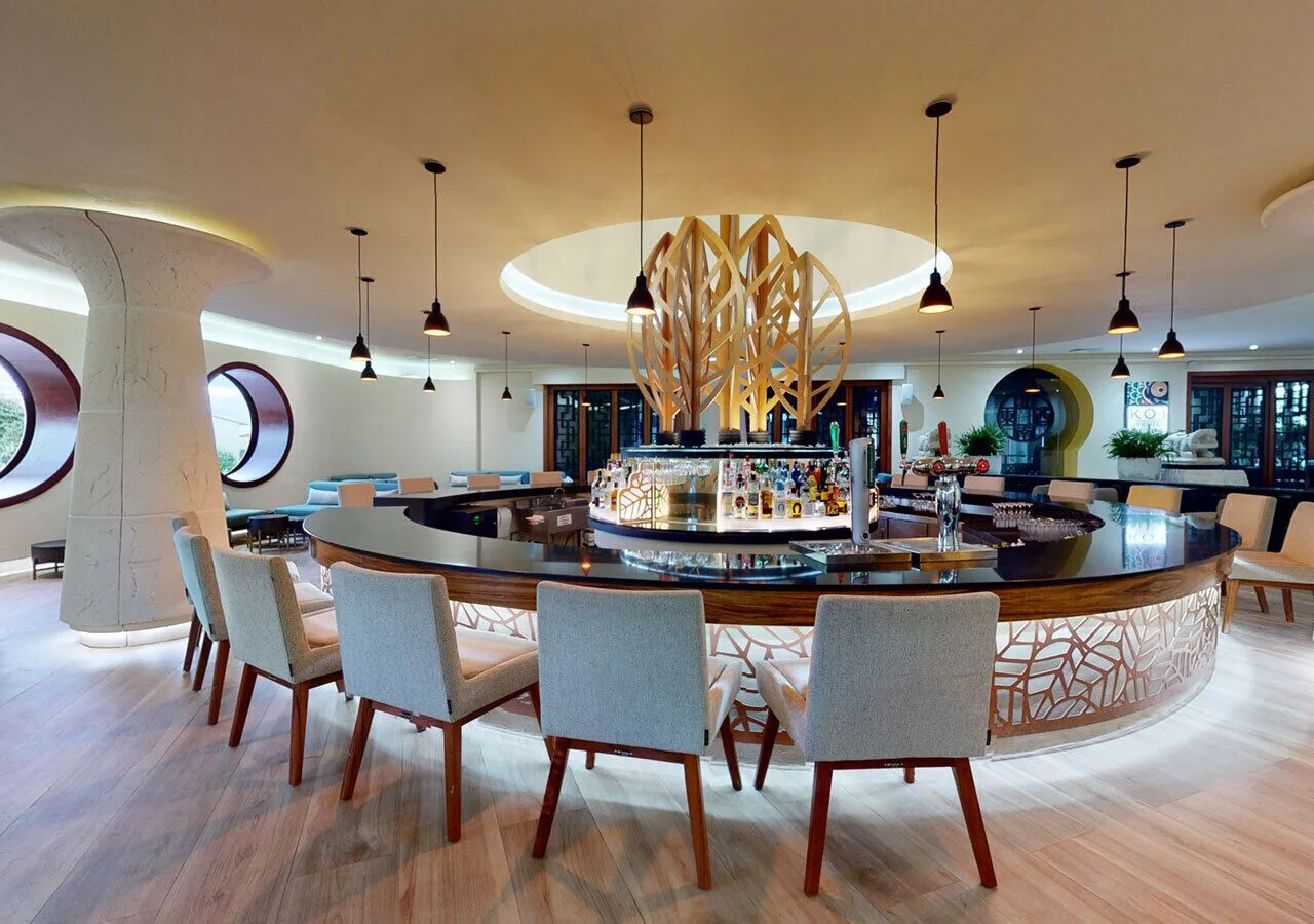 Circular lobby bar with pendant lights at Grand Park Royal Cancun.