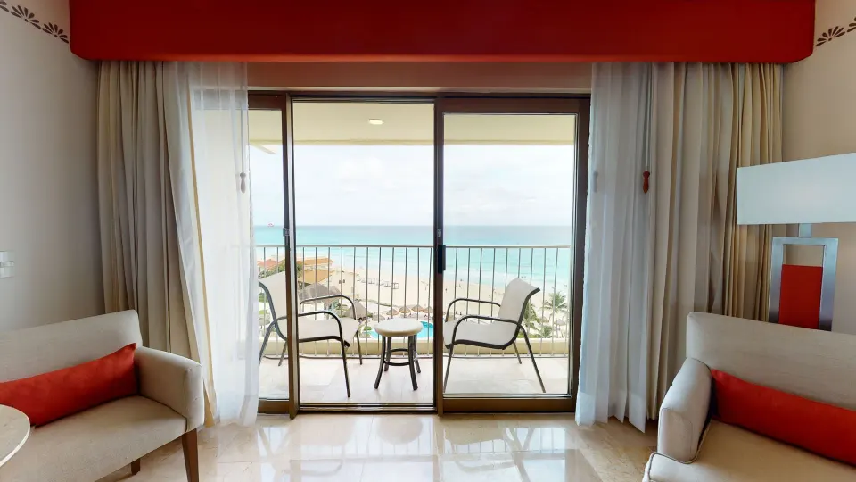 Deluxe Ocean View balcony doors and ocean view at Grand Park Royal Cancun.