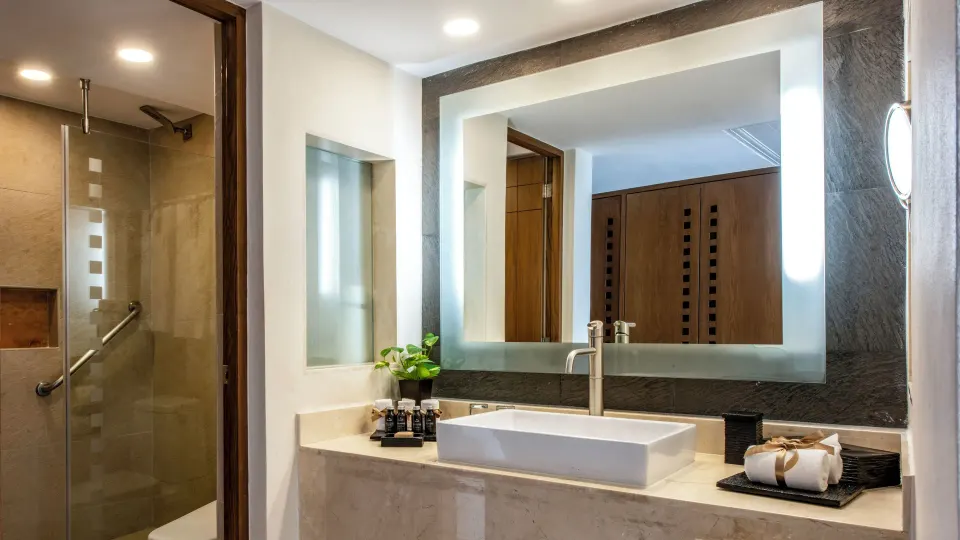 Deluxe Ocean View bathroom sink and glass shower at Grand Park Royal Cancun.