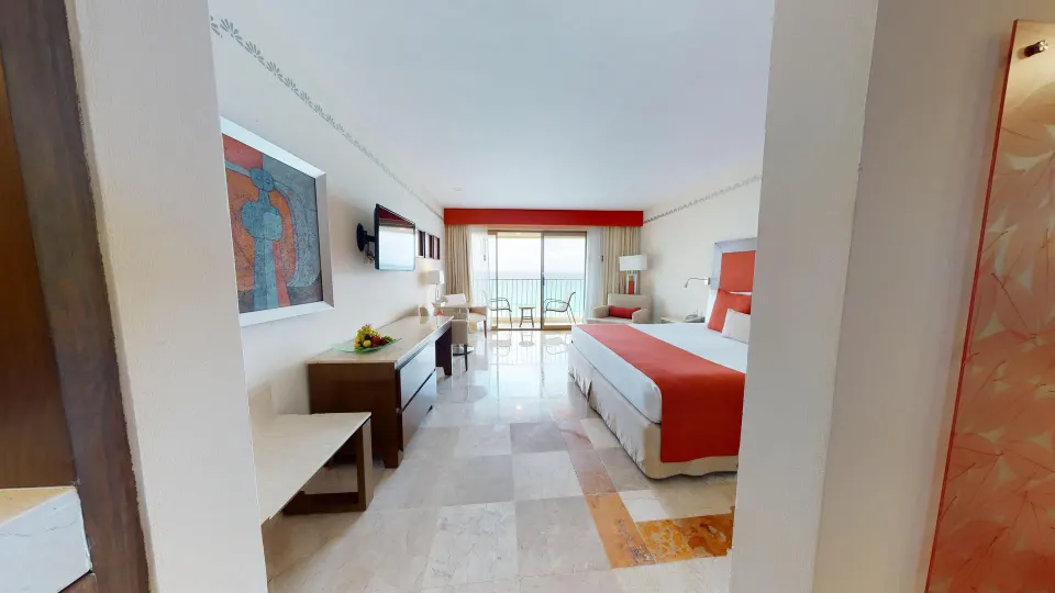 Deluxe Ocean View room with king bed and balcony at Grand Park Royal Cancun.