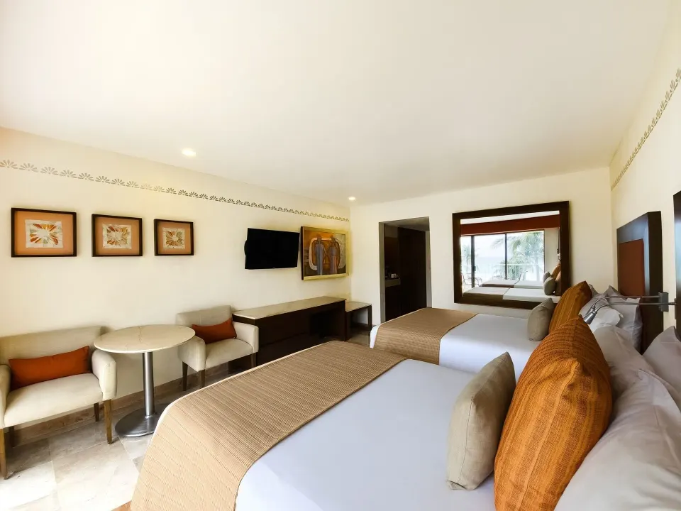 Deluxe Ocean View two beds and seating area at Grand Park Royal Cancun.