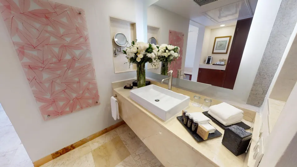 Deluxe Swim Up bathroom vanity with sink and amenities at Grand Park Royal Cancun.