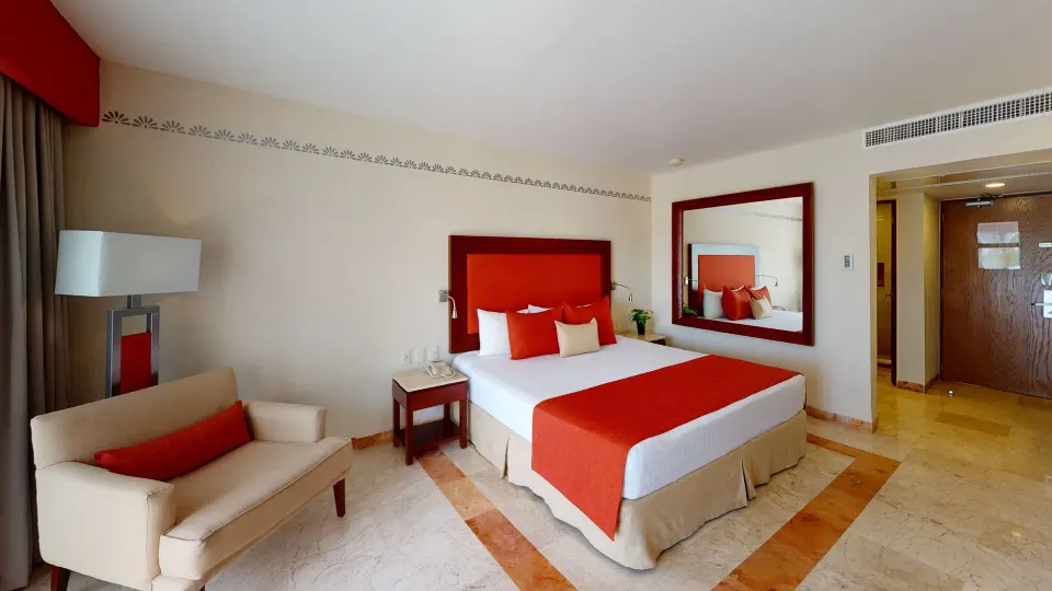 Deluxe Swim Up king bed and lounge chair near the entry at Grand Park Royal Cancun.