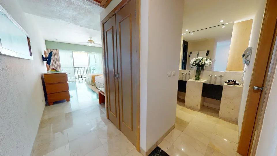 Premier Ocean Front Doble entry hall, closet, bathroom, and bedroom at Grand Park Royal Cancun.