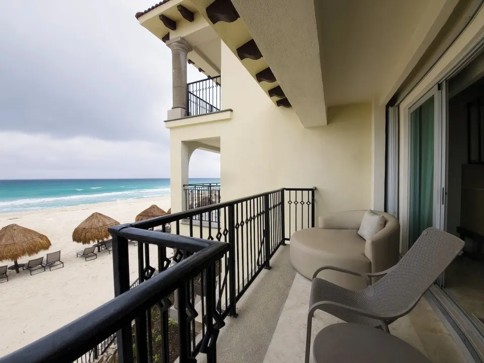 Royal Suite balcony with lounge seating and beach view at Grand Park Royal Cancun.
