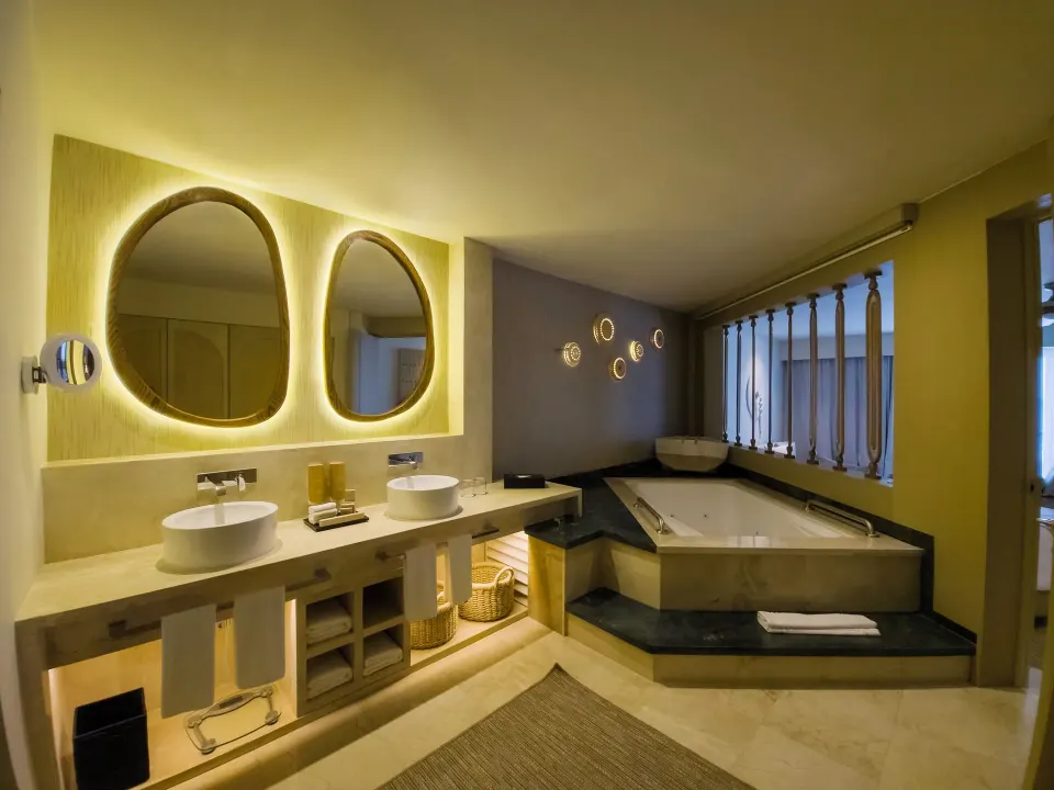 Royal Suite bathroom with double sinks and hot tub at Grand Park Royal Cancun.