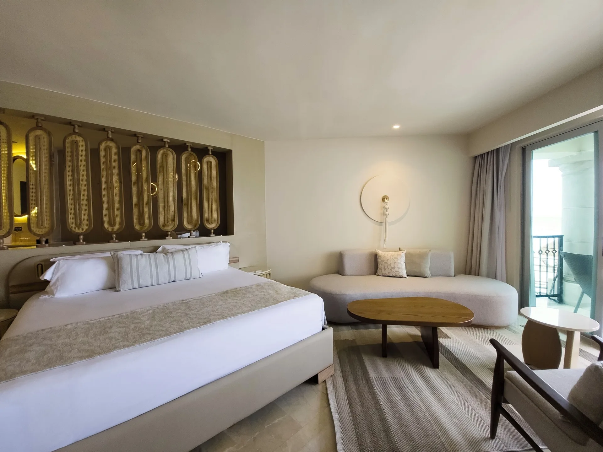 Royal Suite king bed and sitting area at Grand Park Royal Cancun.