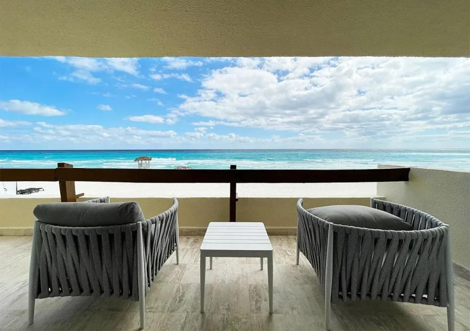 Villa Deluxe Ocean Front balcony seating and sea view at Grand Park Royal Cancun.
