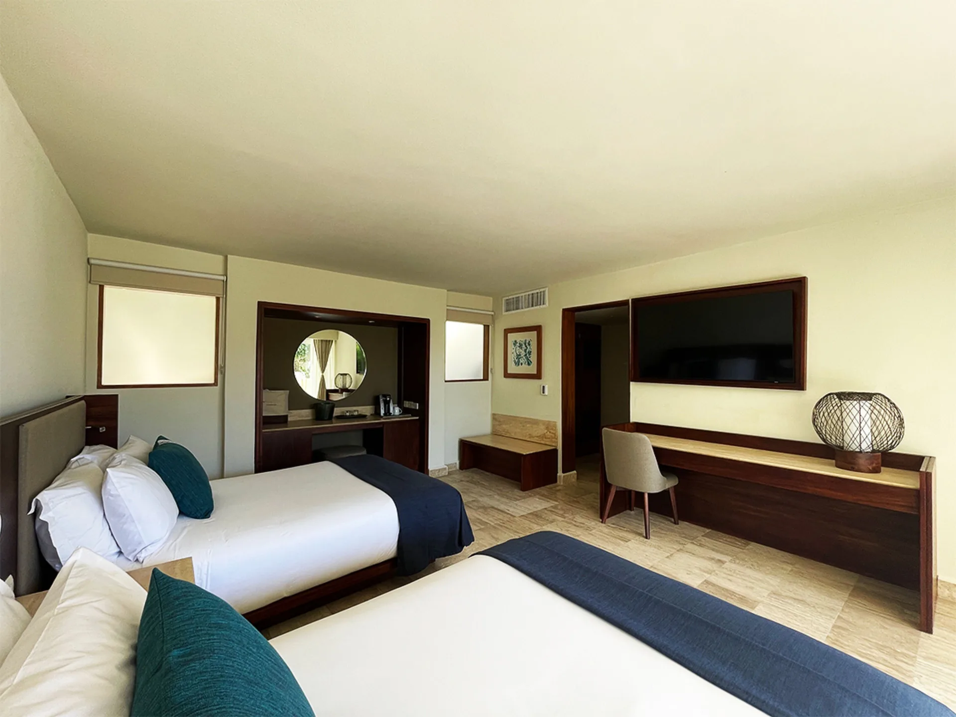Villa Junior Suite with two beds, vanity, desk and TV at Grand Park Royal Cancun.