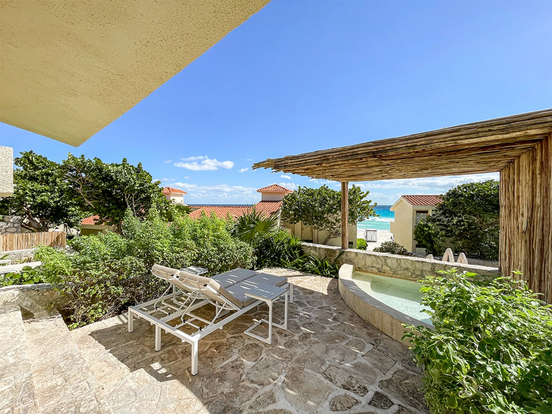 Villa Master Suite terrace with plunge pool and ocean glimpse at Grand Park Royal Cancun.