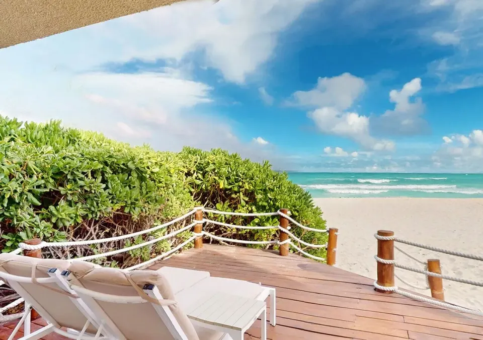 Villa Premier Plungepool Oceanfront deck with loungers and beach view at Grand Park Royal Cancun.