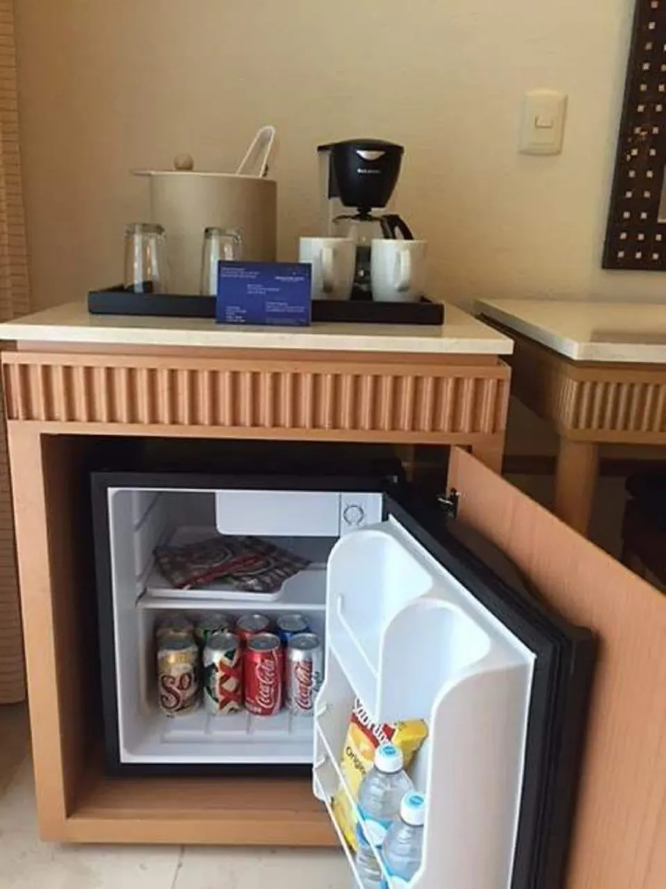 Open minibar and coffee setup in guest room at Grand Park Royal Cozumel