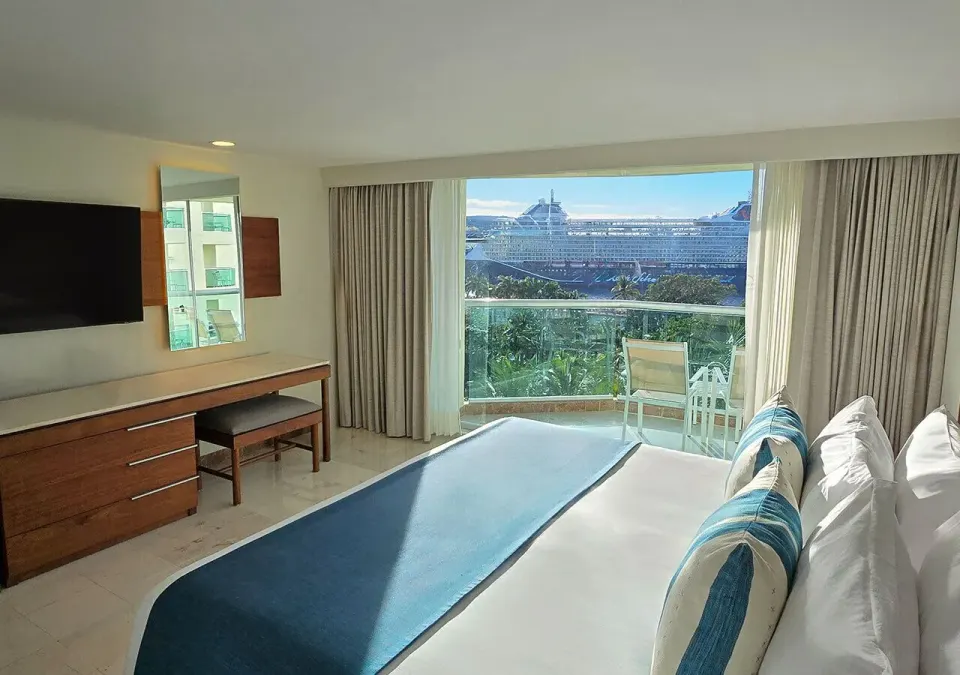 King bed and balcony with cruise ship view at Grand Park Royal Cozumel