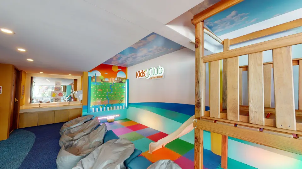 Indoor kids club play area with colorful mats and wooden play structure at Grand Park Royal Cozumel