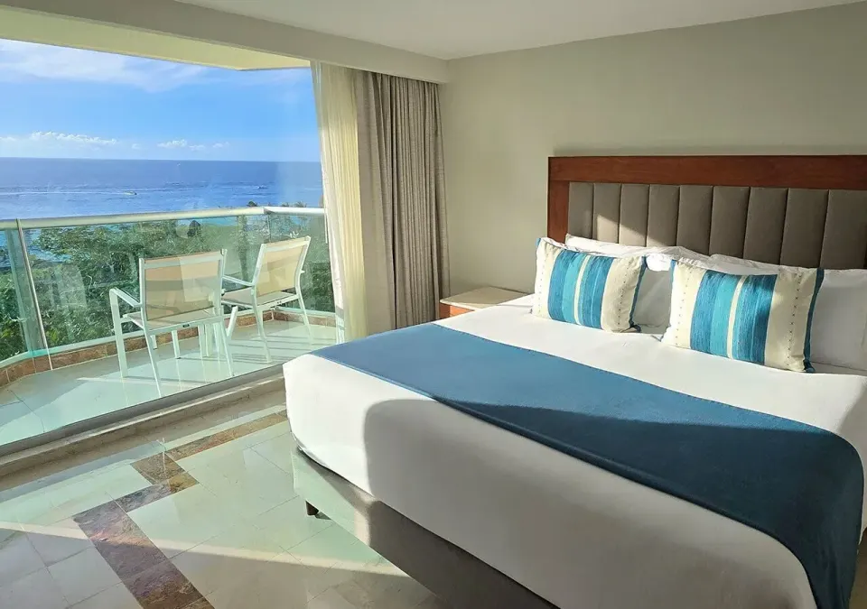 King bed and balcony with ocean view at Grand Park Royal Cozumel