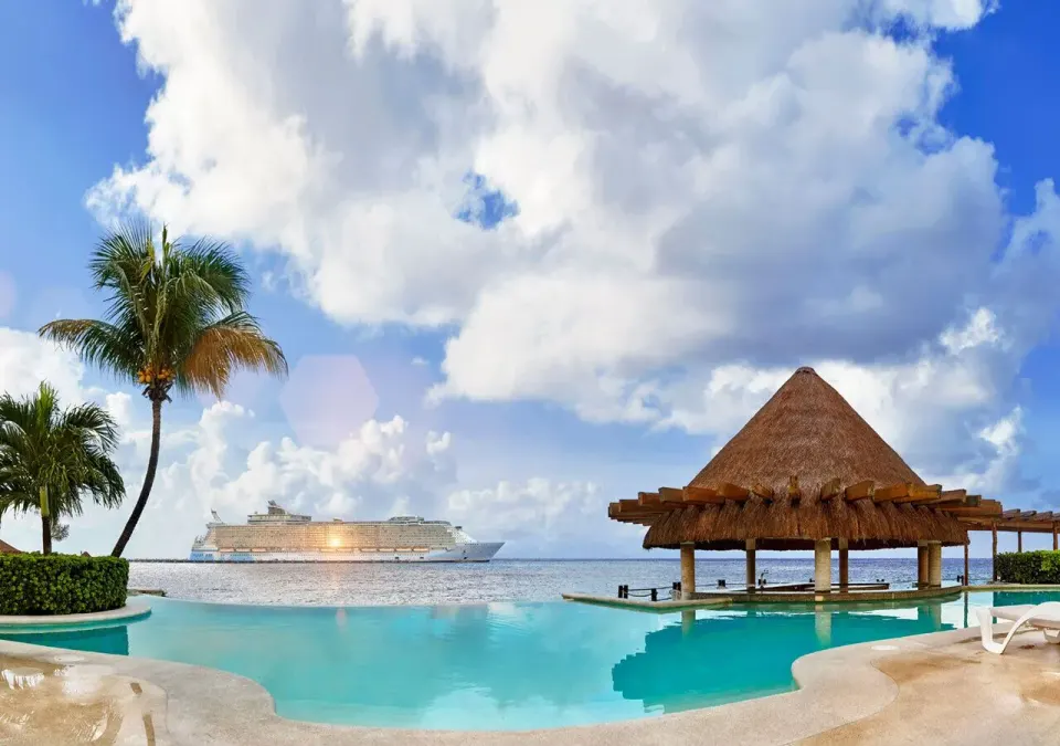 Infinity pool and palapa over the sea with a cruise ship on the horizon at Grand Park Royal Cozumel