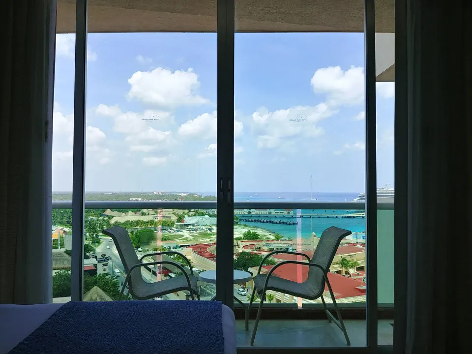 Balcony chairs with harbor view from guest room at Grand Park Royal Cozumel
