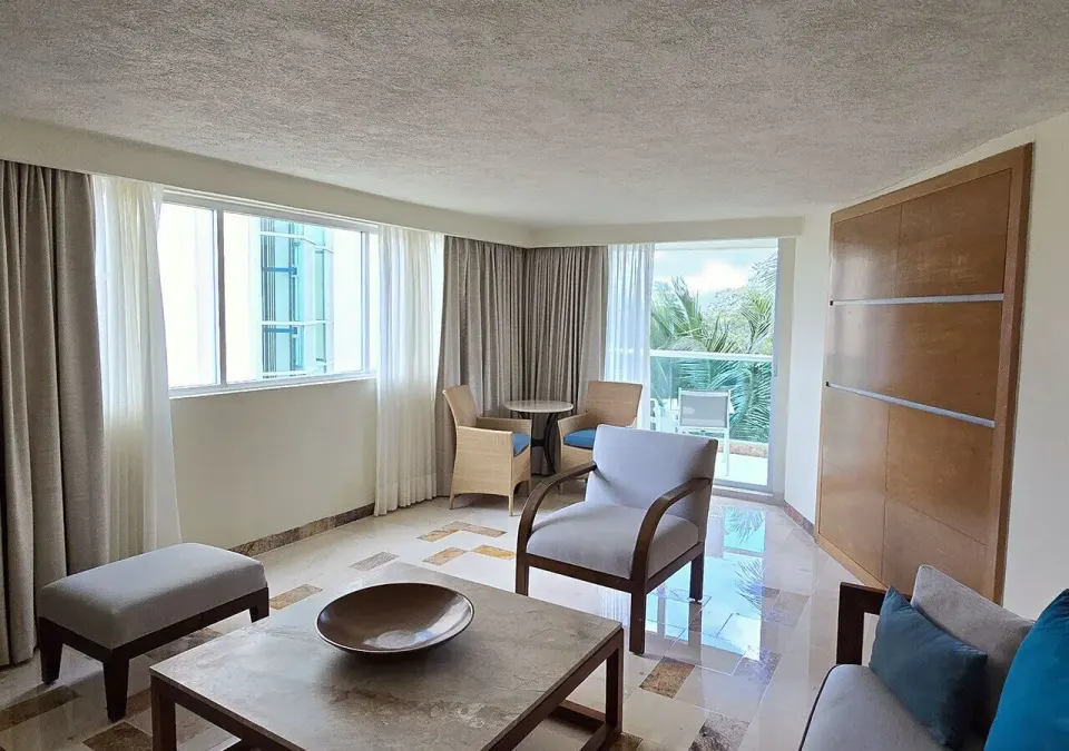 Wide-angle view of suite seating area and balcony at Grand Park Royal Cozumel