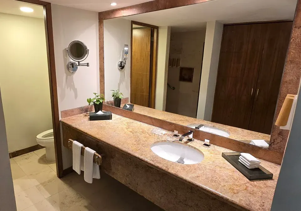 Bathroom vanity with sink and large mirror in Deluxe Nature View Double at Grand Park Royal Cozumel