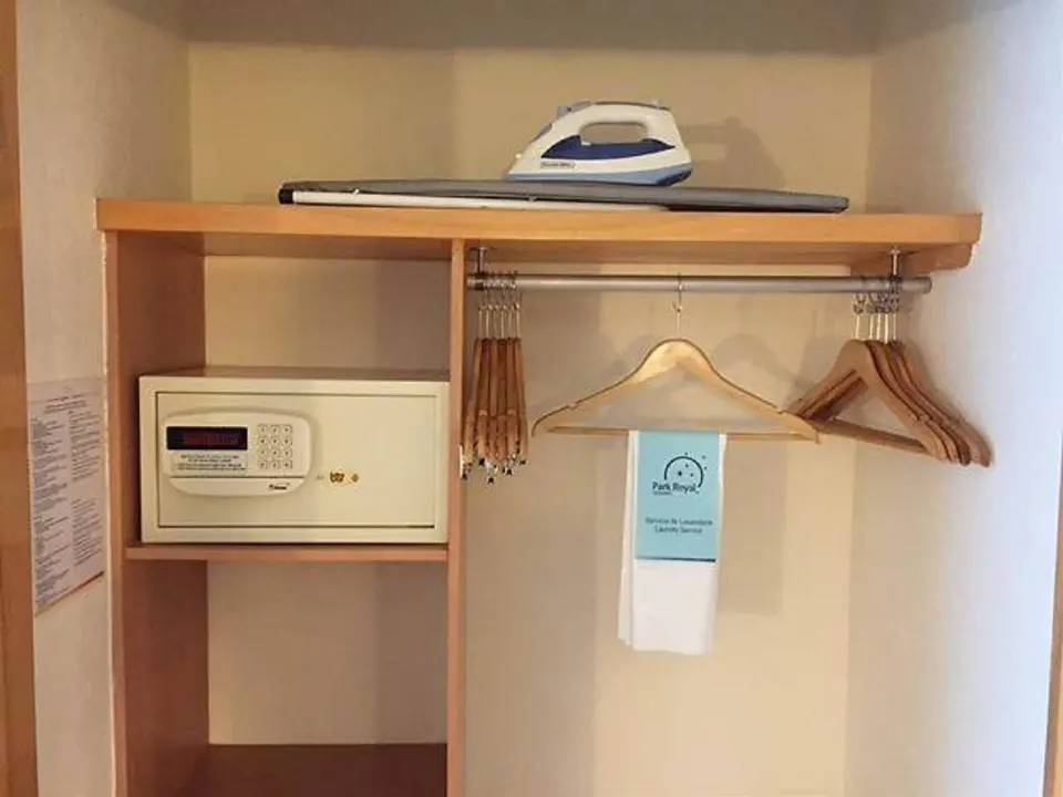 Open closet with safe, hangers and iron in Deluxe Nature View Double at Grand Park Royal Cozumel