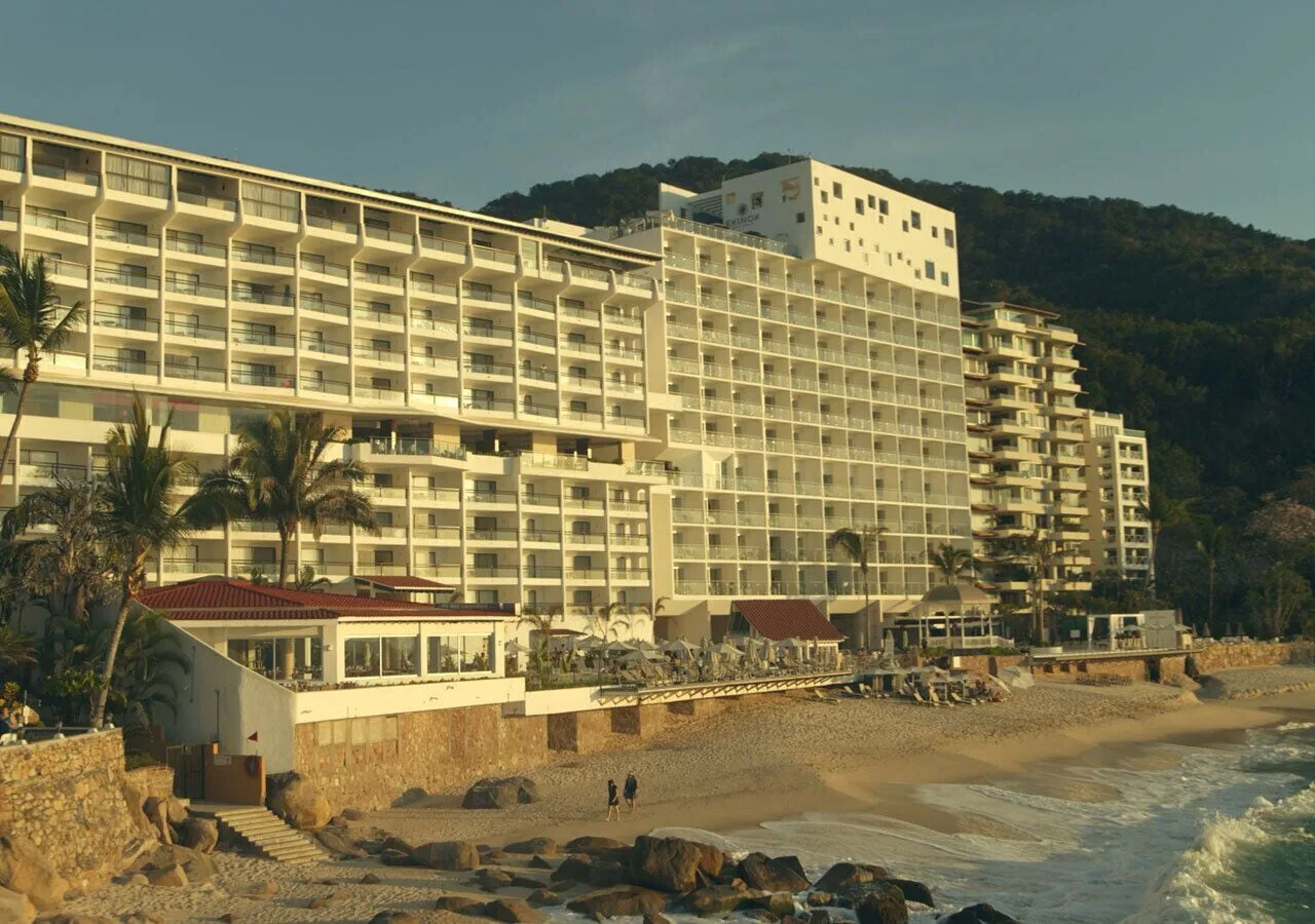 Beachfront resort towers rise above the shore at Grand Park Royal Puerto Vallarta.