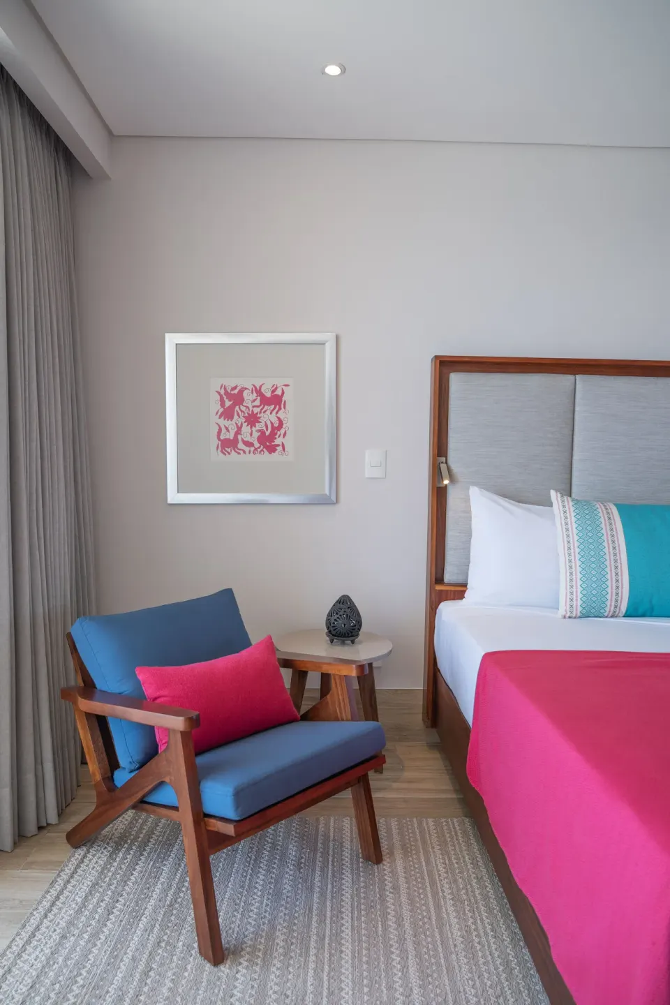 Guest room seating area and partial king bed at Grand Park Royal Puerto Vallarta.