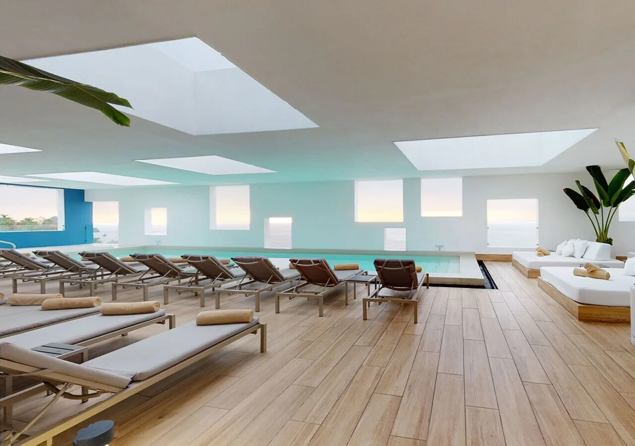 Indoor pool deck with loungers and skylights at Grand Park Royal Puerto Vallarta.