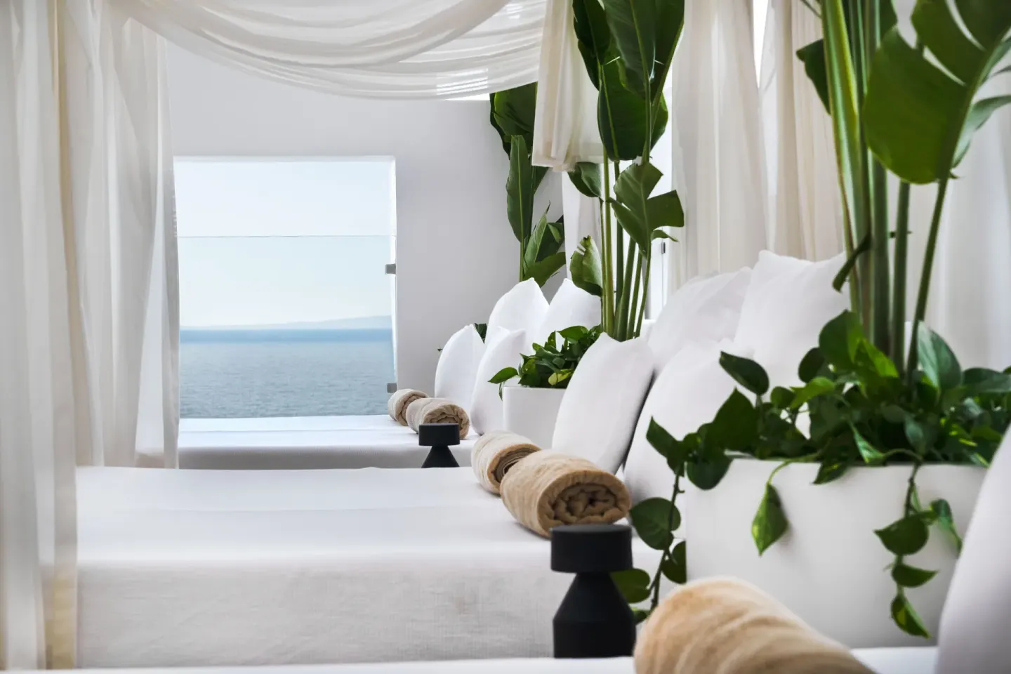 White spa loungers facing the ocean at Grand Park Royal Puerto Vallarta.