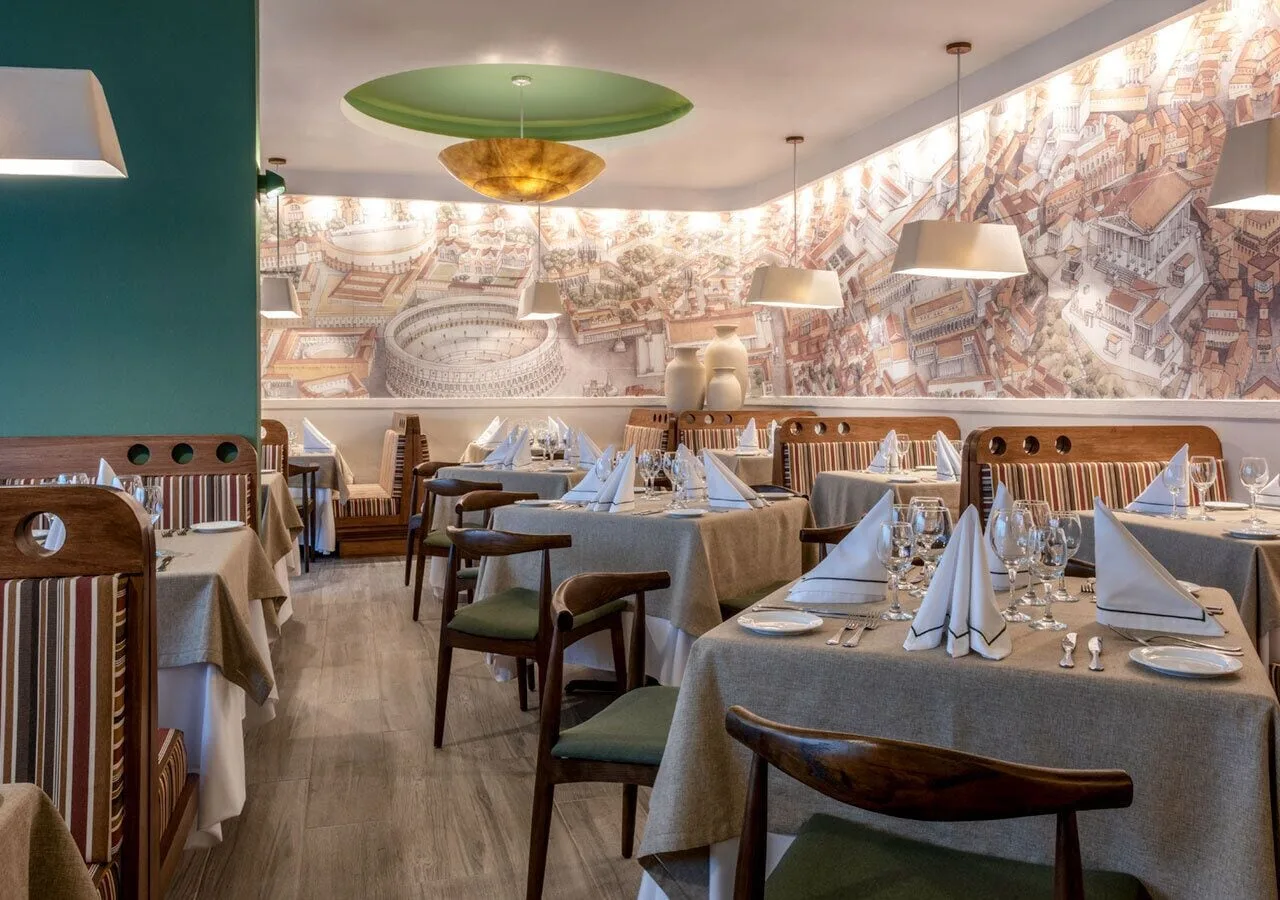 Elegant dining room with set tables and mural at Grand Park Royal Puerto Vallarta.