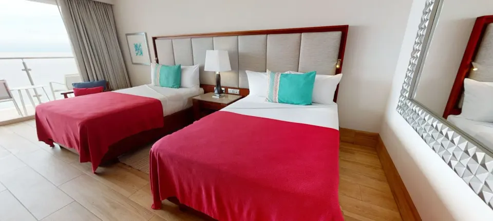 Two-bed Deluxe Ocean Front room with mirror at Grand Park Royal Puerto Vallarta.