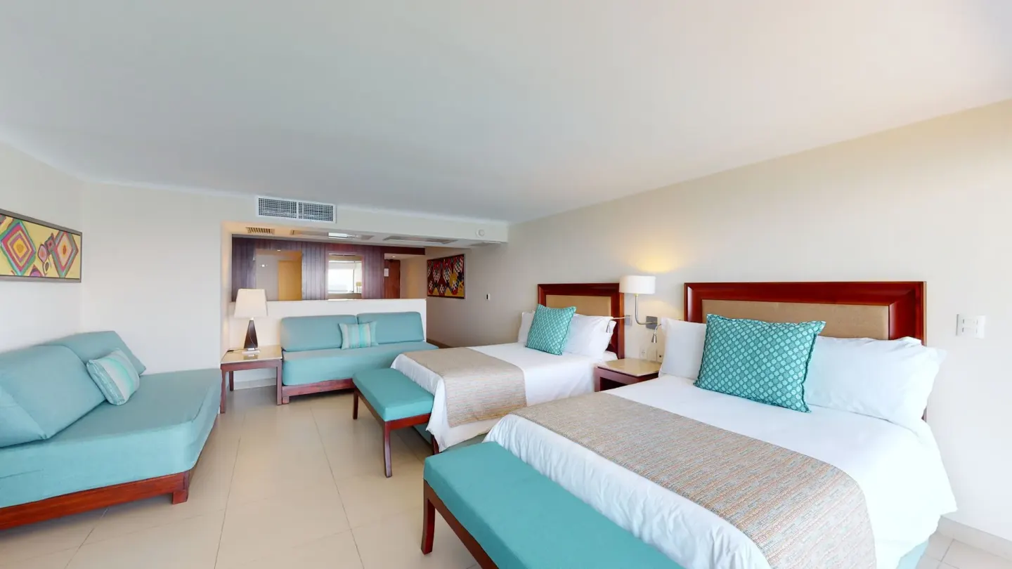 Family Suite with two beds and aqua seating at Grand Park Royal Puerto Vallarta.