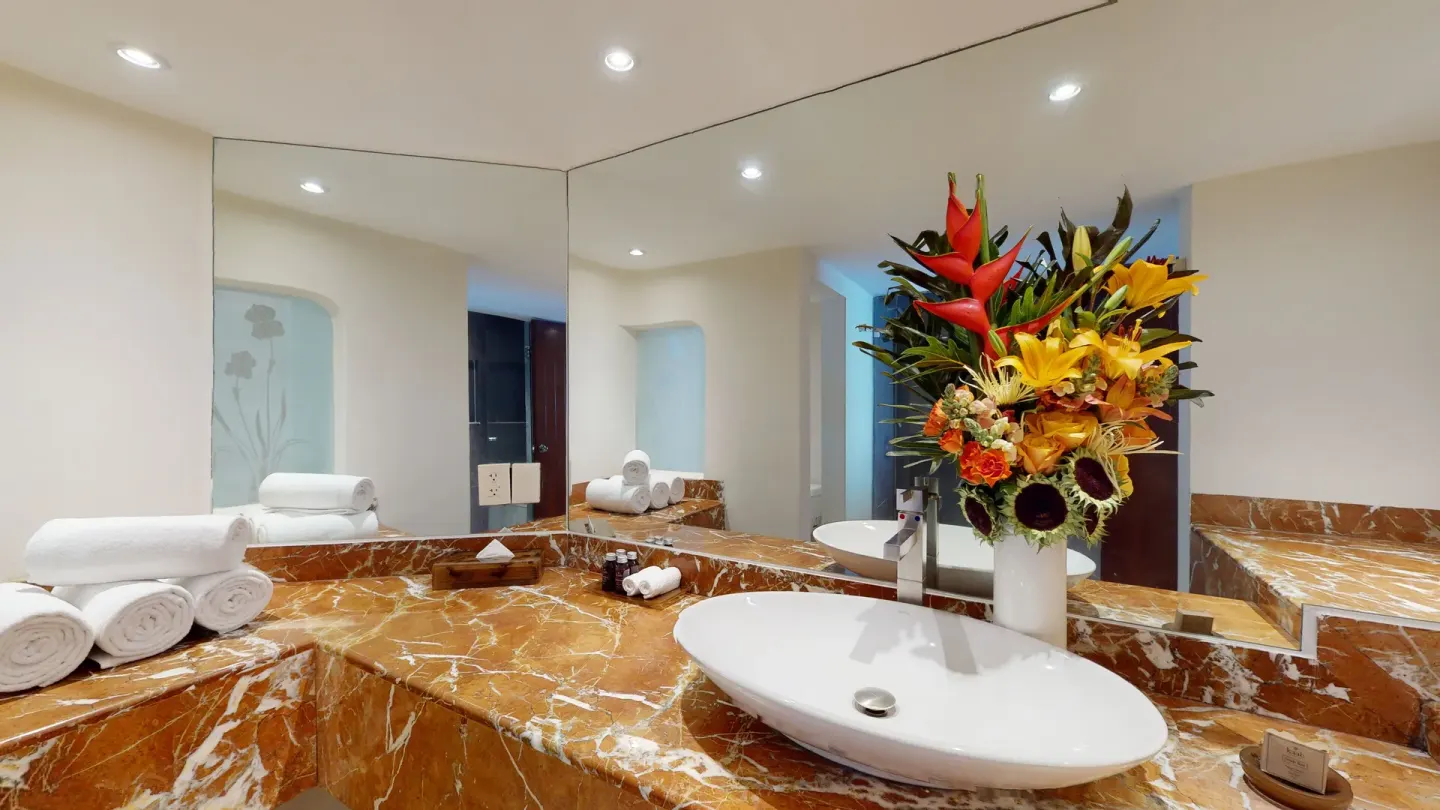 Junior Suite bathroom vanity and flowers at Grand Park Royal Puerto Vallarta.