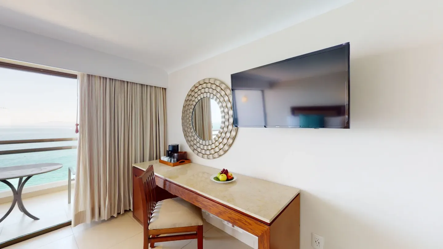 Junior Suite desk, TV and balcony view at Grand Park Royal Puerto Vallarta.