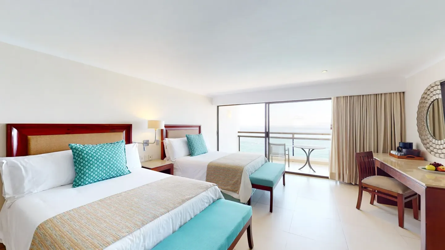 Junior Suite with two beds and balcony at Grand Park Royal Puerto Vallarta.