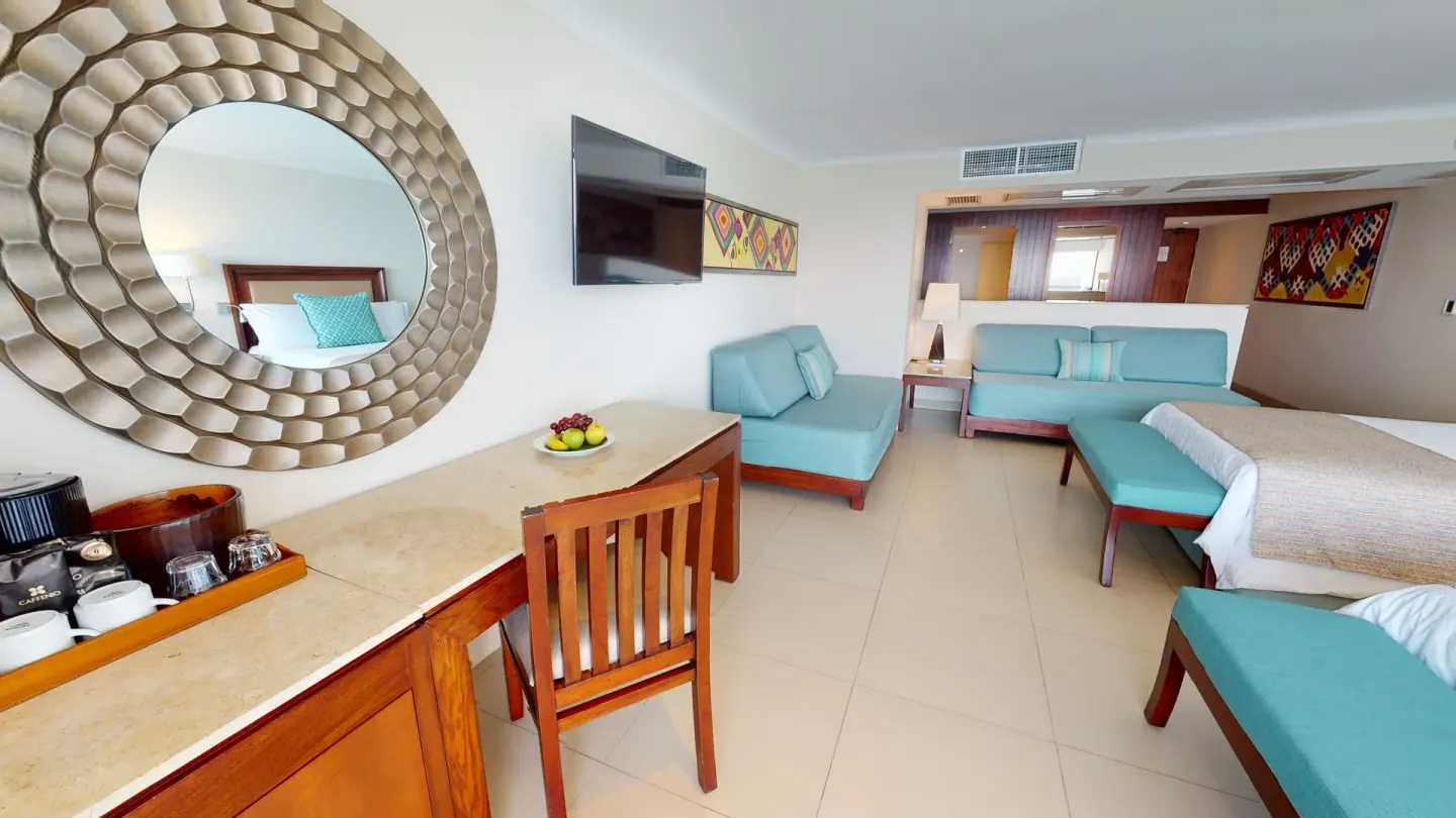 Junior Suite seating area and two beds at Grand Park Royal Puerto Vallarta.